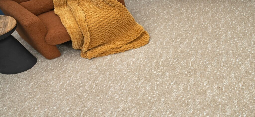 Beige patterned carpet flooring in a cozy living room