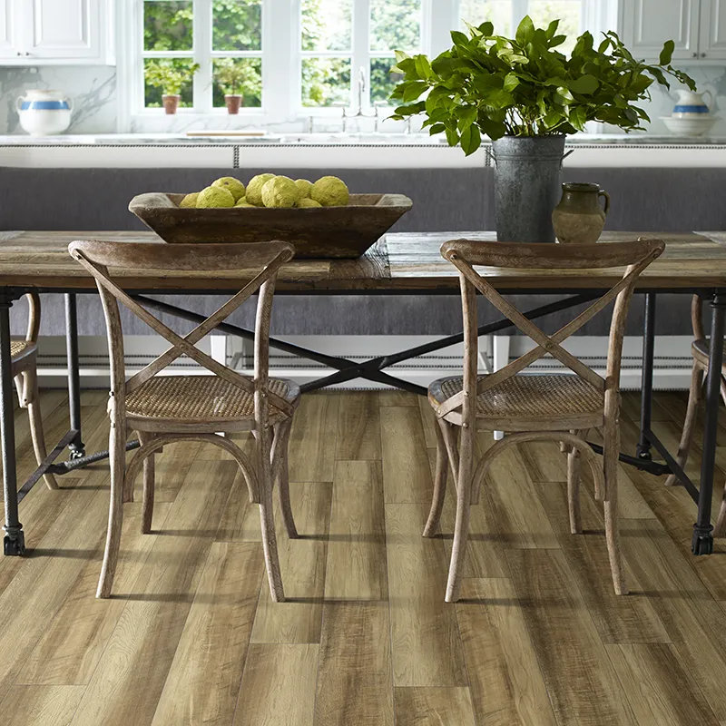 Dining room with wood look LVP flooring and bright sun from window
