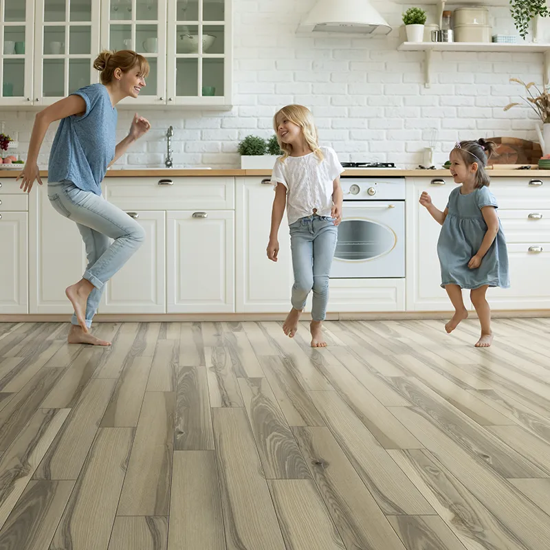 Family dancing on lvp flooring in kitchen
