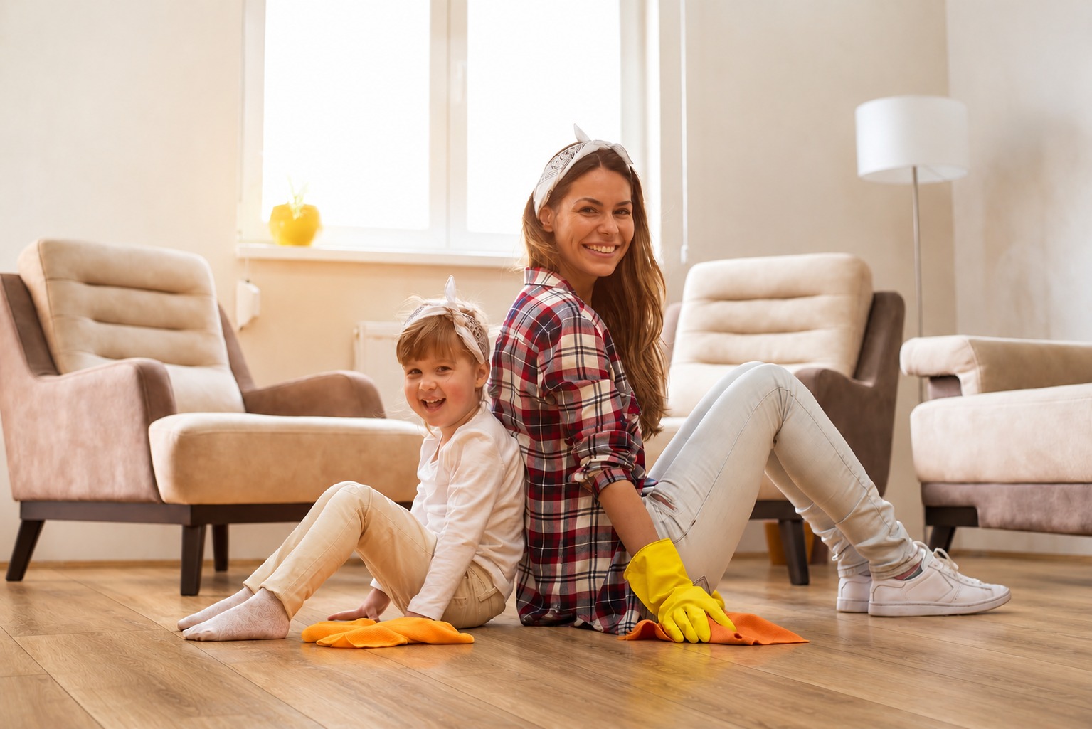 Family cleaning luxury vinyl flooring in a bright living room