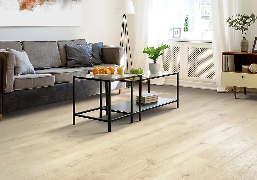 Wide-Plank Wide plank laminate flooring in living room with gray couch and coffee table