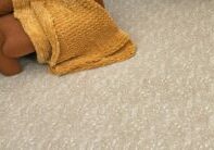 Beige patterned carpet flooring in a cozy living room